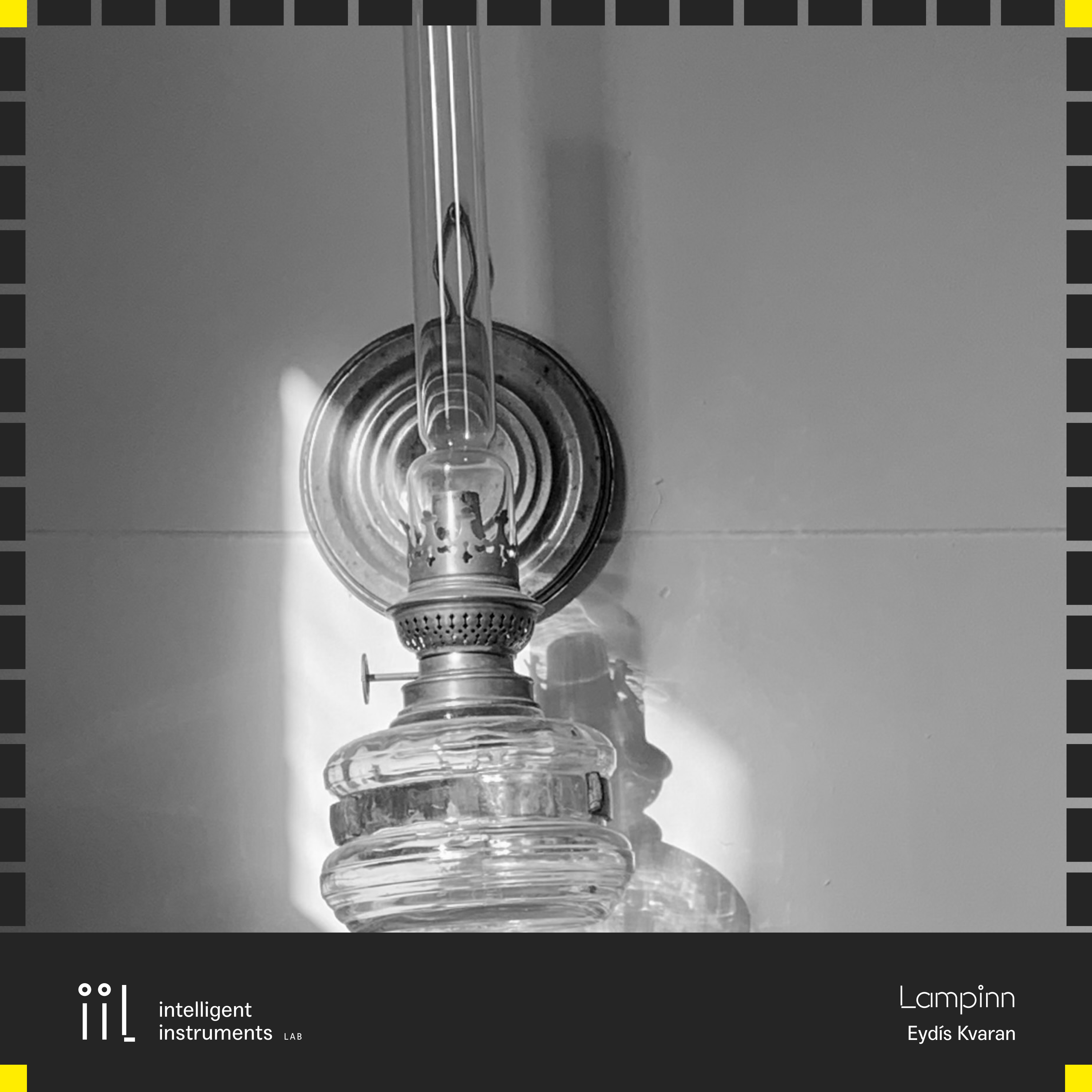 A black and white picture of an oil lamp on a wall, with the release frame