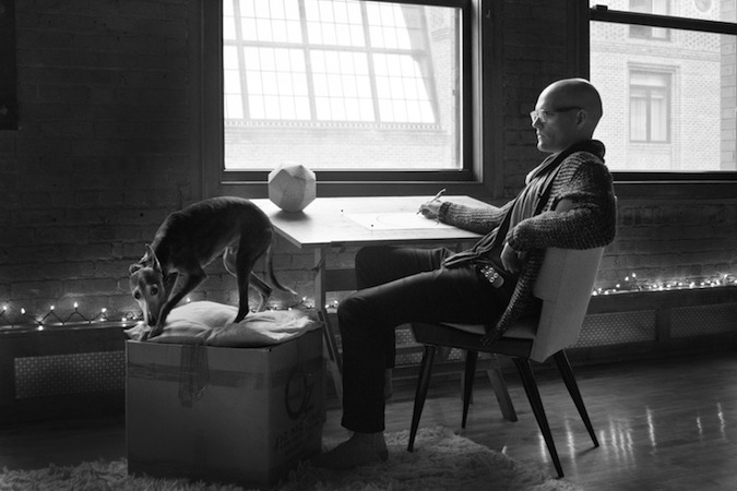 black and white photo of a man and a dog in a living room