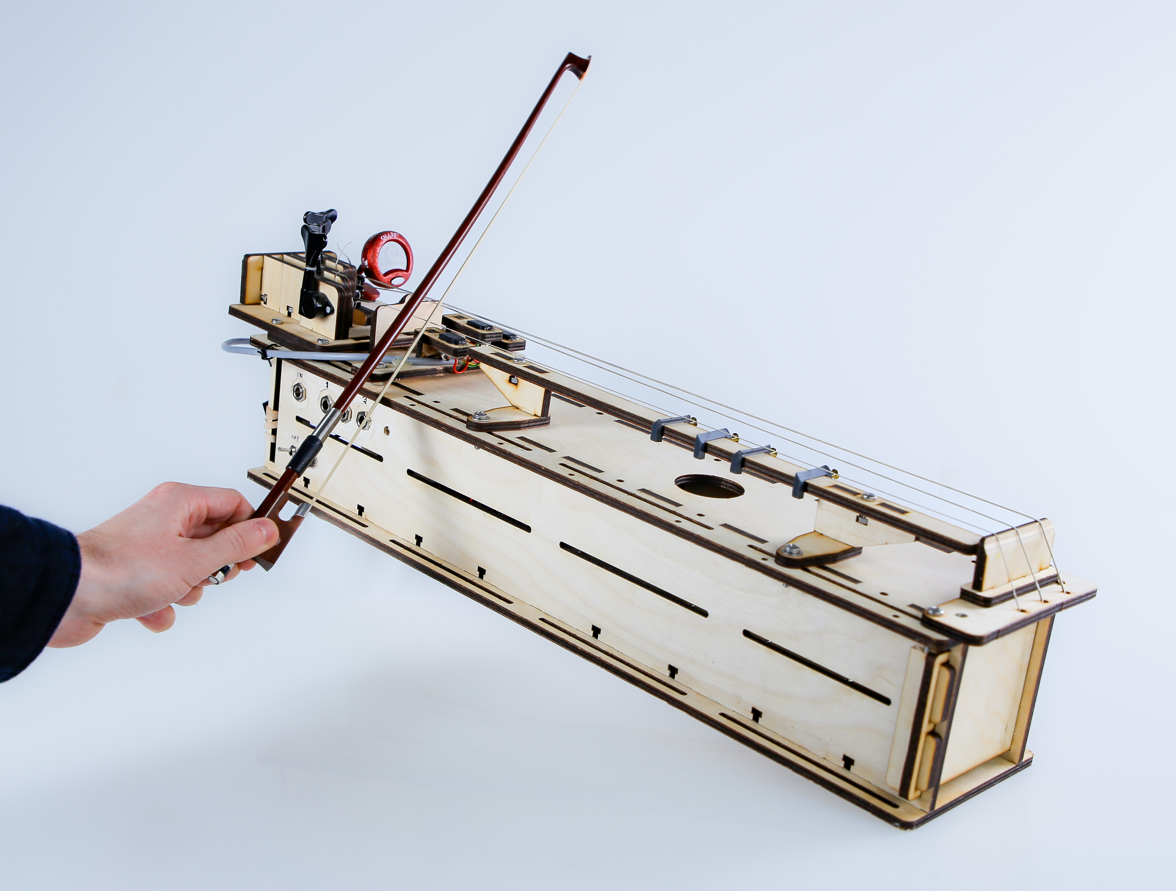 An electronic string instrument being played with a bow.