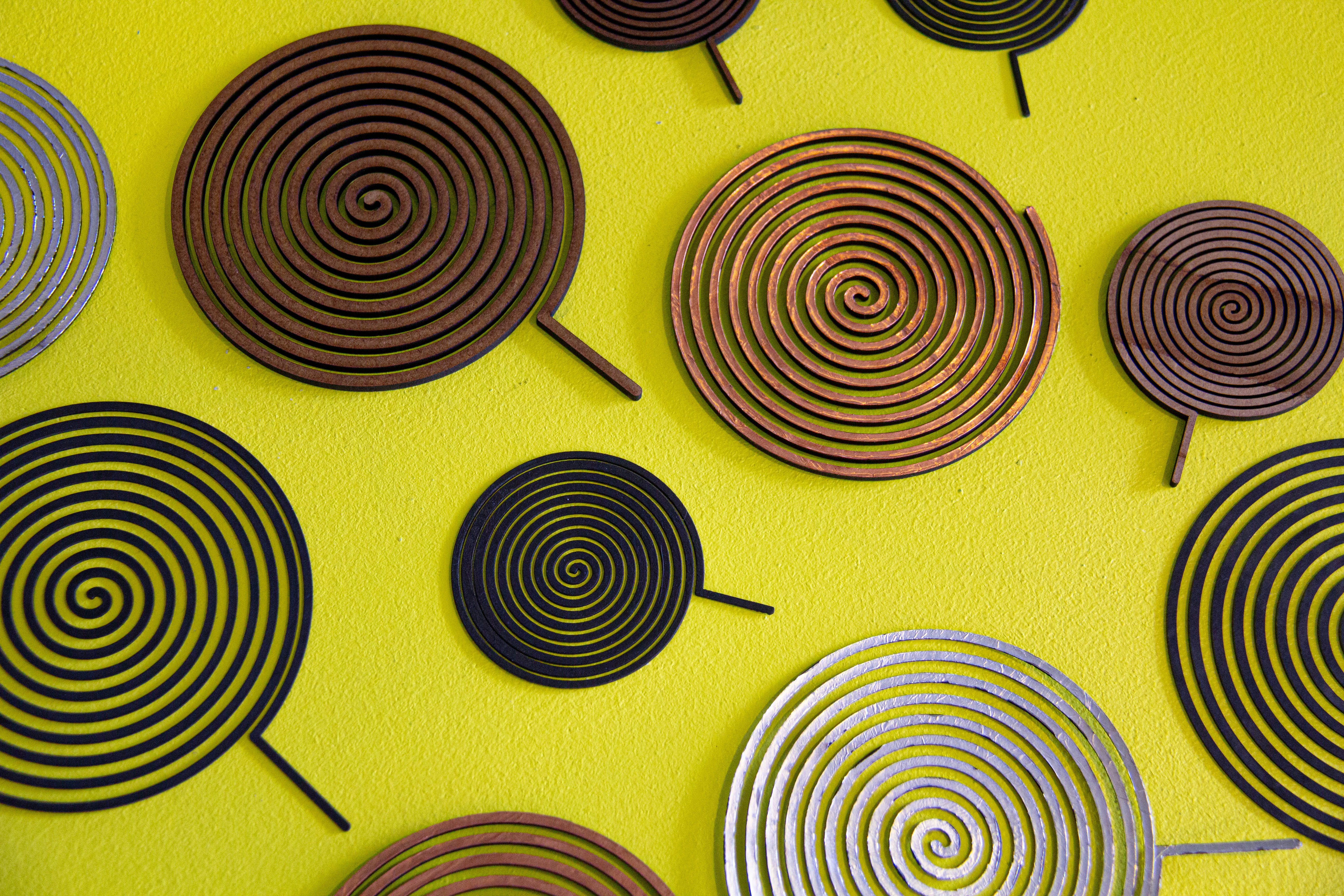 Copper spirals on a yellow surface.