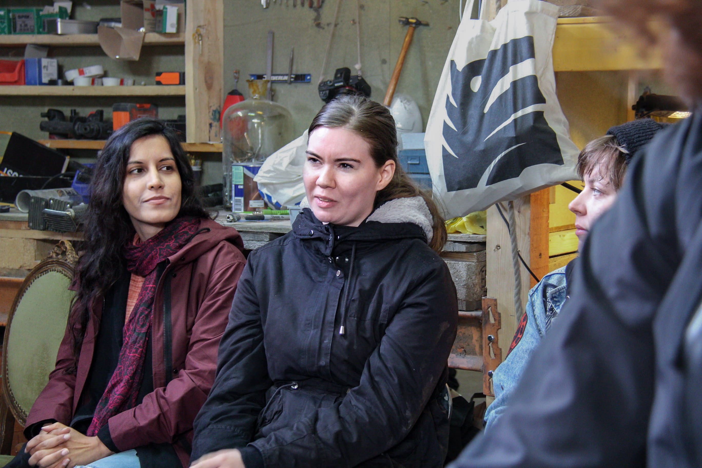 People sitting in a workshop space.