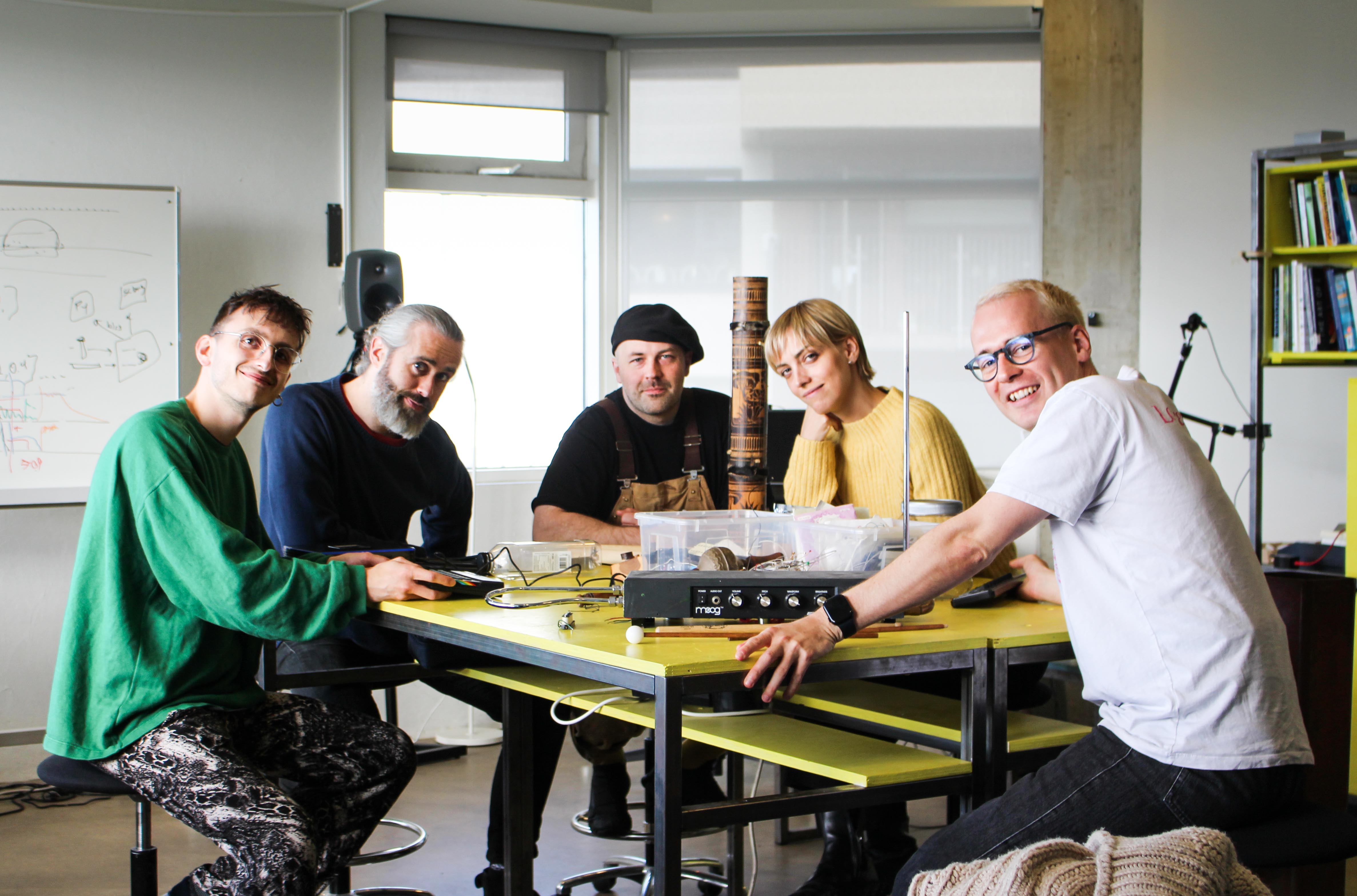 A group of workshop leaders sitting and smiling.