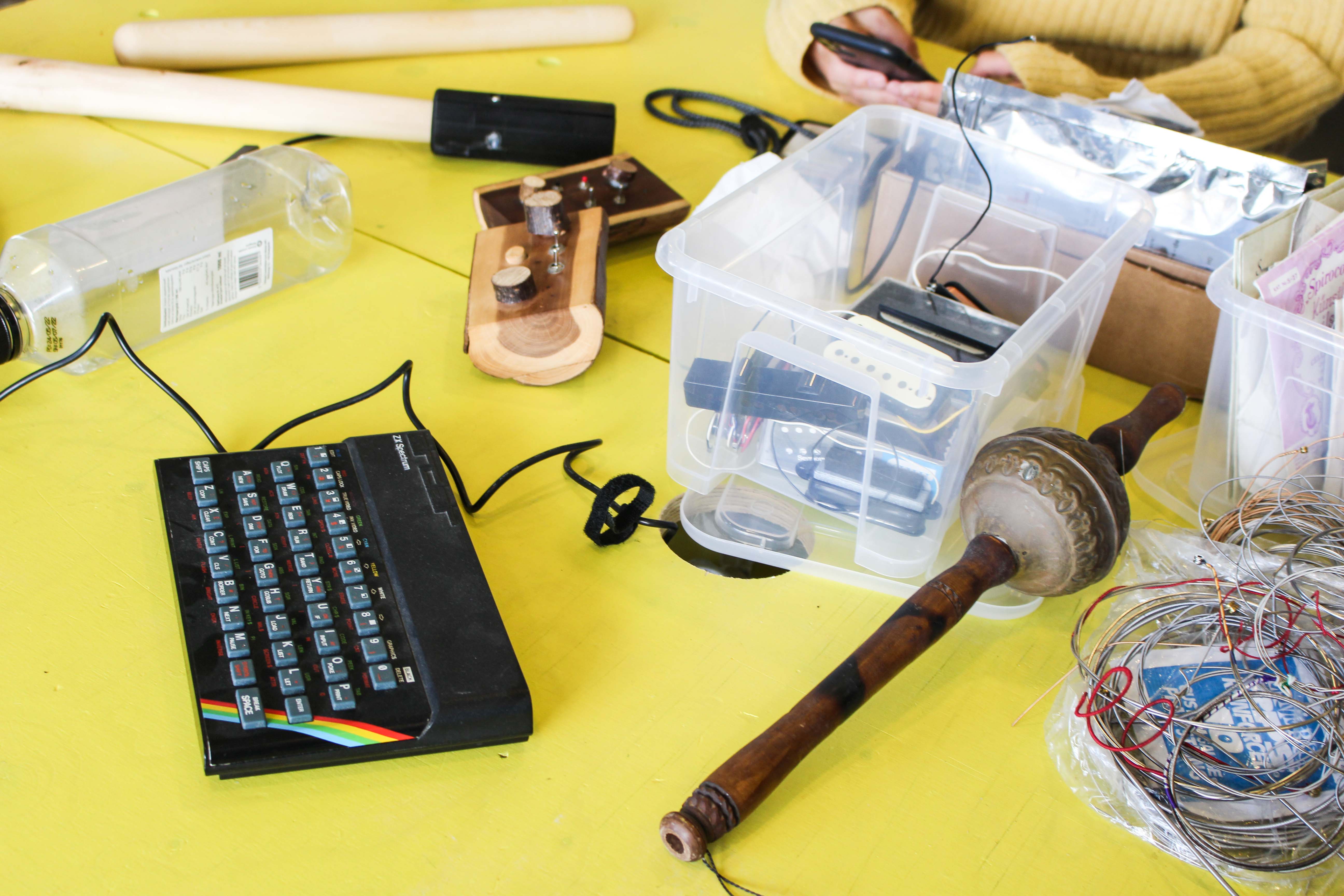 Various musical instruments and other things on a yellow surface.