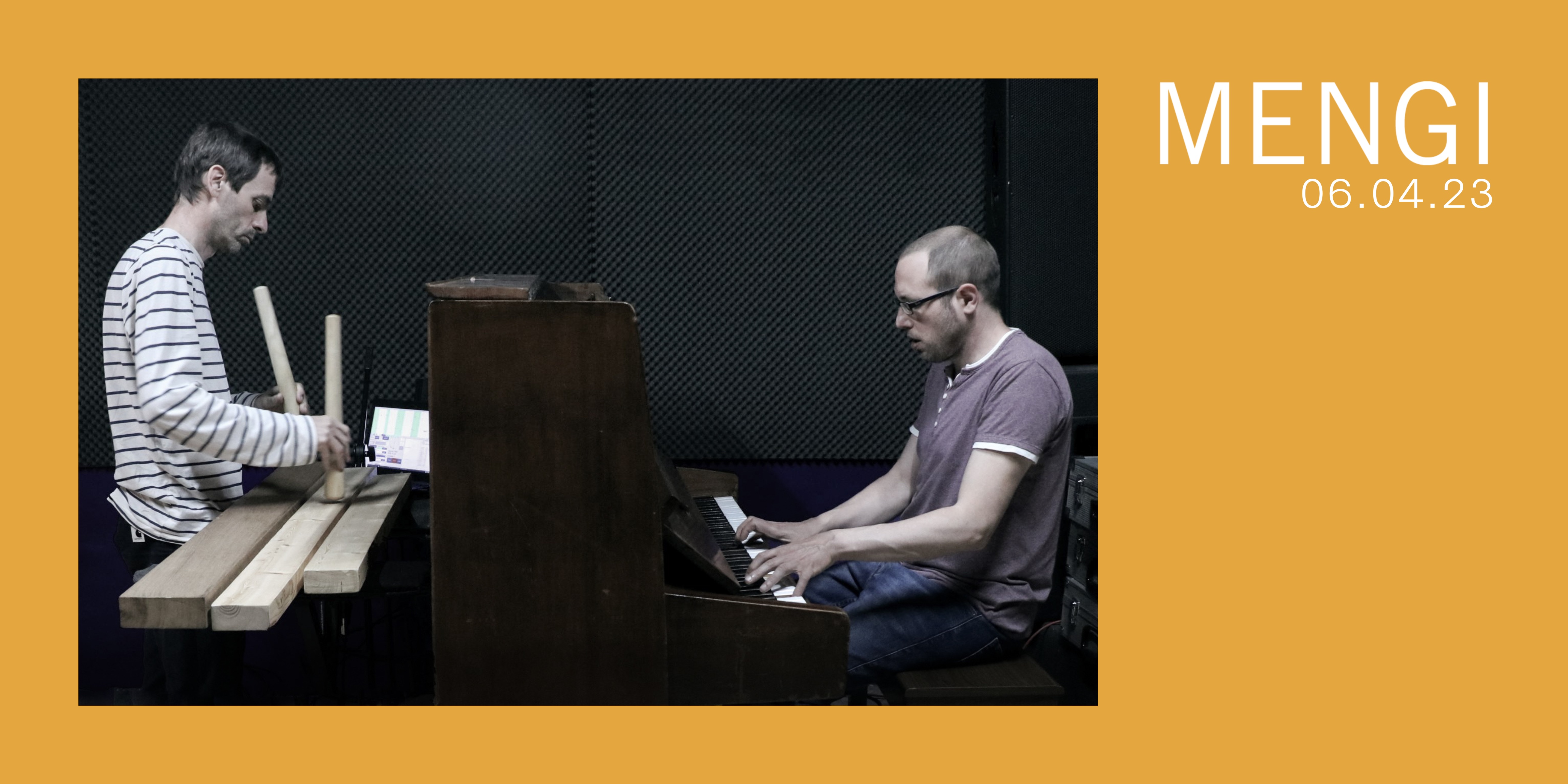 A yellow typical Mengi poster with a picture of two men in front of their instruments, one in front of a piano and the other one in front of a txalaparta, wooden planks.