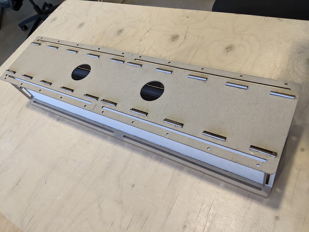 A simple cardboard prototype of a long box-shaped instrument.